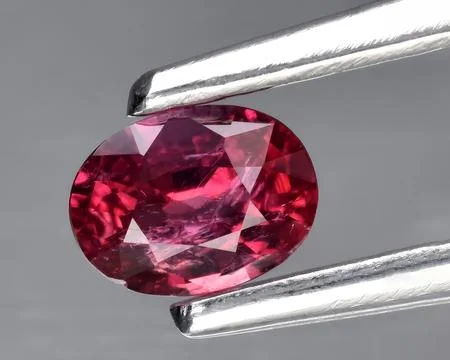 Natural pink red ruby gem on the background Stock Photos