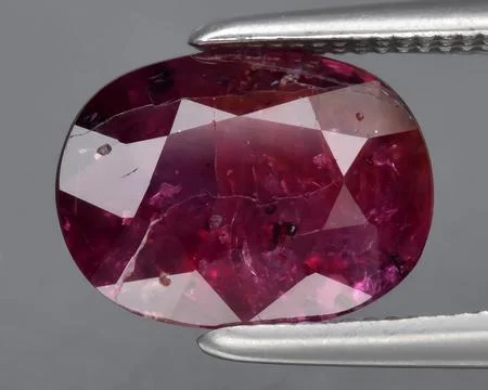 Natural pink red ruby gem on the background Stock Photos