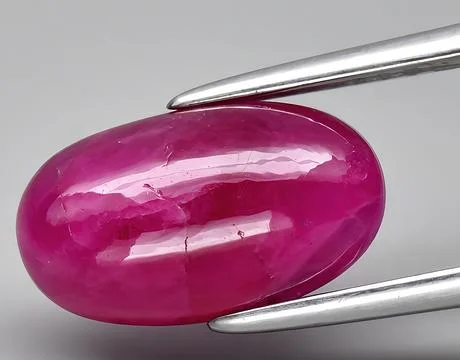 Natural pink ruby gem on the background Stock Photos