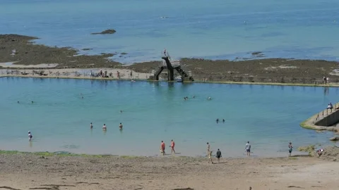 Natural pool on the beach people jumping into the water from a height Stock Footage 136033482