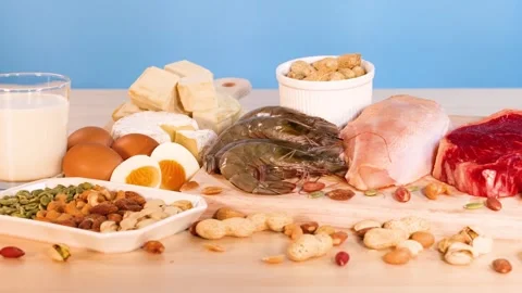 Natural protein sources including meat fish dairy nuts and eggs on wooden t.. Stock Footage 333824865