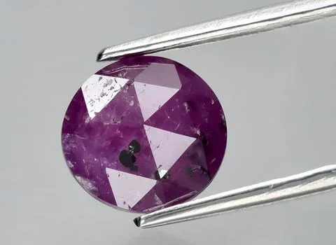 Natural purple ruby gem on the background Stock Photos
