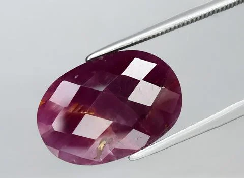Natural purple ruby gem on the background Stock Photos