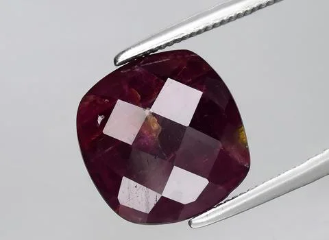Natural purple ruby rough gem on the background Stock Photos
