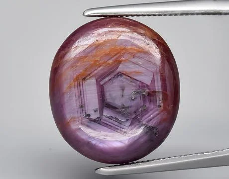 Natural purple ruby rough gem on the background Stock Photos