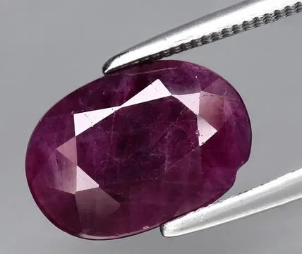 Natural red ruby corrundum gem on the background Stock Photos