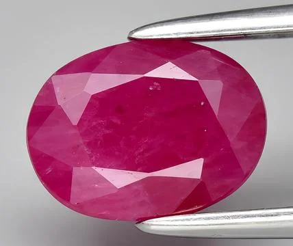 Natural red ruby corrundum gem on the background Stock Photos