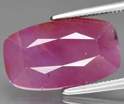 Natural red ruby corrundum gem on the background Stock Photos