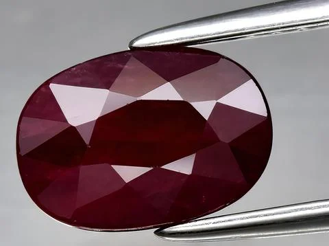 Natural red ruby corrundum gemstone on the background Stock Photos