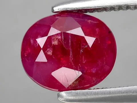 Natural red ruby corrundum gemstone on the background Stock Photos