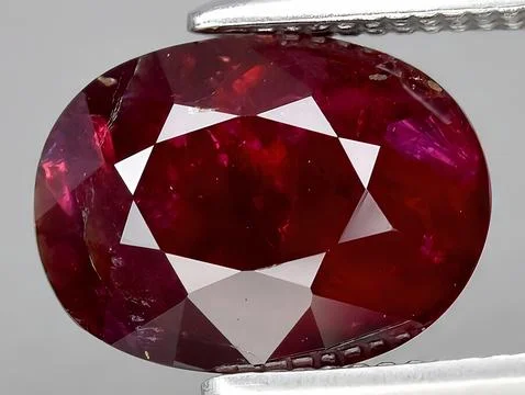 Natural red ruby corrundum gemstone on the background 스톡 사진