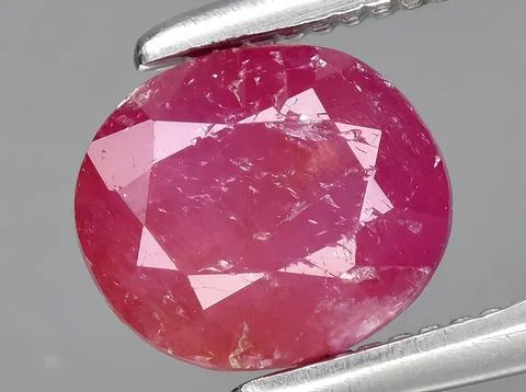Natural red ruby corrundum gemstone on the background Stock Photos