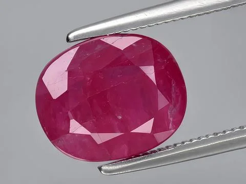 Natural red ruby corrundum gemstone on the background Stock Photos