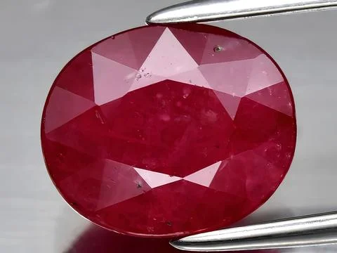 Natural red ruby corrundum gemstone on the background Stock Photos