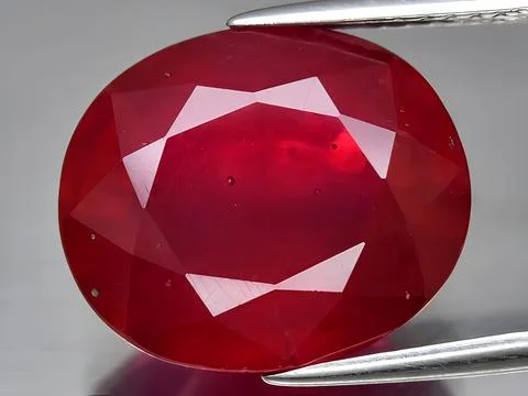 Natural red ruby corrundum gemstone on the background Stock Photos