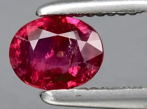 Natural red ruby gem on the background Stock Photos