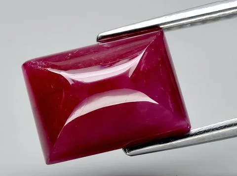 Natural red ruby gem on the background 스톡 사진