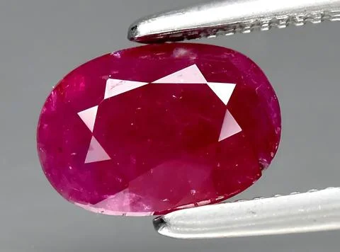 Natural red ruby gem on the background Stock Photos