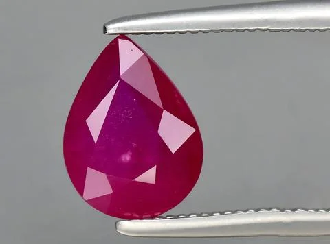 Natural red ruby gem on the background 스톡 사진