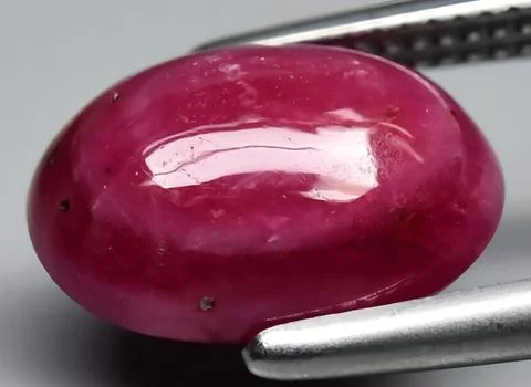 Natural red ruby gem on the background 스톡 사진
