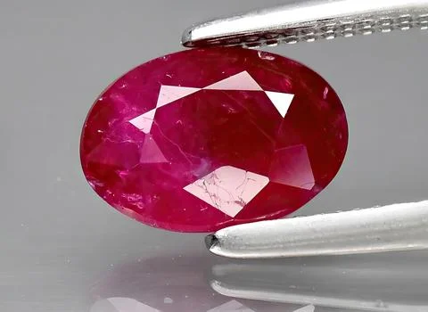Natural red ruby gem on the background Stock Photos