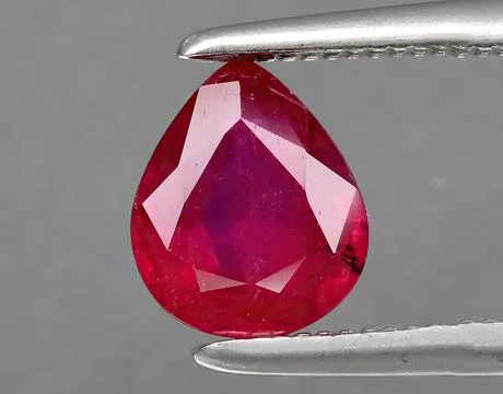 Natural red ruby gem on the background 스톡 사진