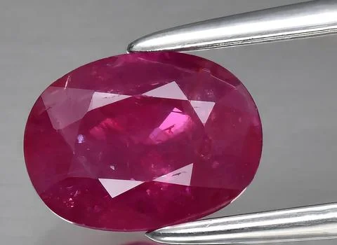 Natural red ruby gem on the background Stock Photos