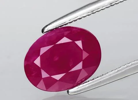 Natural red ruby gem on the background Stock Photos