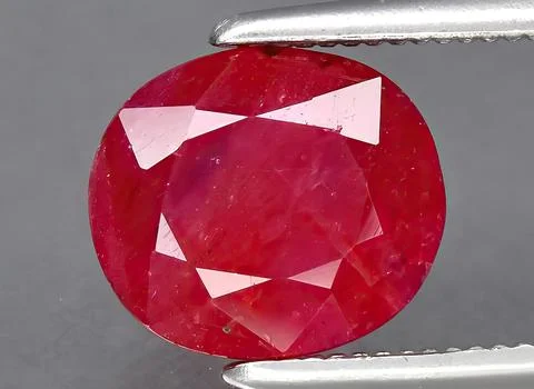 Natural red ruby gem on the background Stock Photos