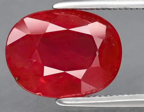 Natural red ruby gem on the background Stock Photos