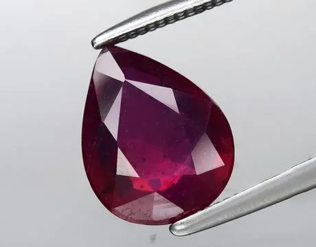 Natural red ruby gem on the background Stock Photos