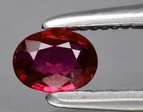 Natural red ruby gem on the background 스톡 사진