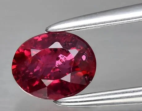 Natural red ruby gem on the background Stock Photos