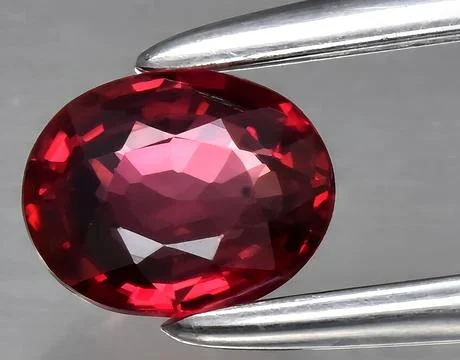 Natural red ruby gem on the background 스톡 사진