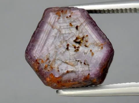 Natural red ruby rough gem on the background Stock Photos