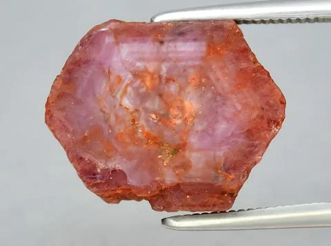 Natural red ruby rough gem on the background Stock Photos