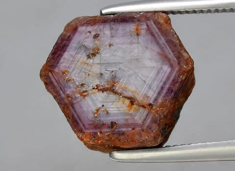 Natural red ruby rough gem on the background Stock Photos