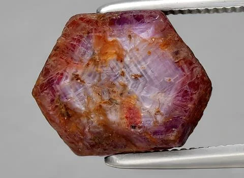 Natural red ruby rough gem on the background Stock Photos