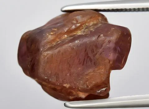 Natural red ruby rough gem on the background Stock Photos