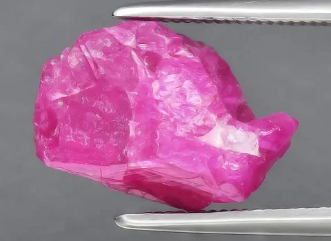 Natural red ruby rough gem on the background Stock Photos