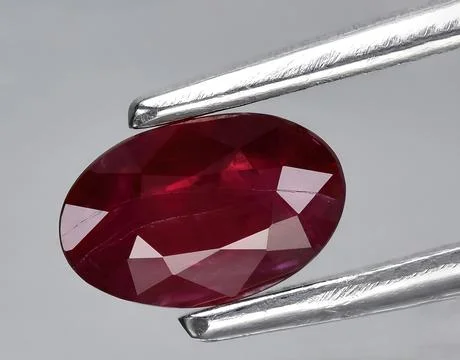 Natural red ruby rough gem on the background Stock Photos