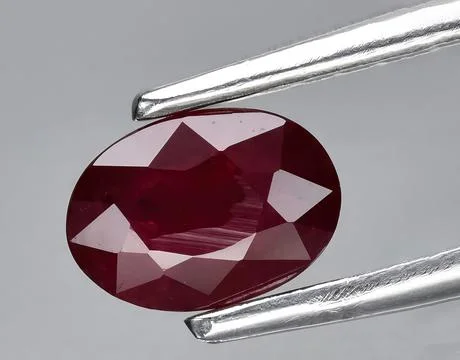 Natural red ruby rough gem on the background Stock Photos