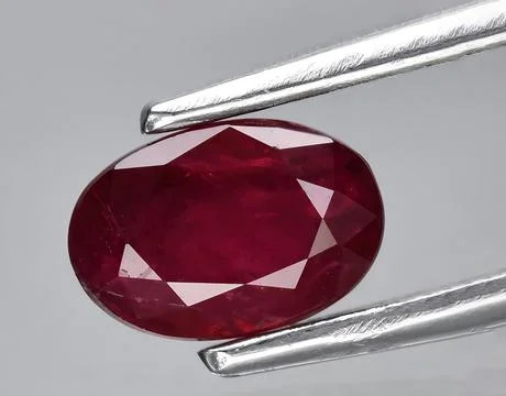 Natural red ruby rough gem on the background Stock Photos
