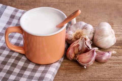 Natural remedy for flu: hot milk and garlic. Stock Photos