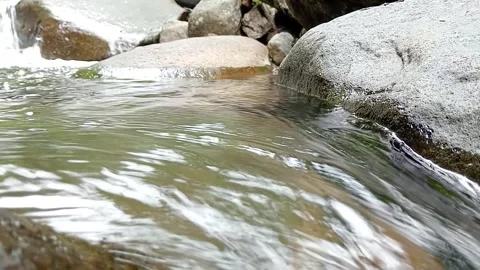 Natural River Current Flowing Between Rocks | Fresh Water Movement Stock Footage 330562102