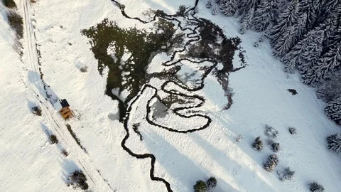 Natural river meanders flowing through snowy countryside Stock Footage 333506216
