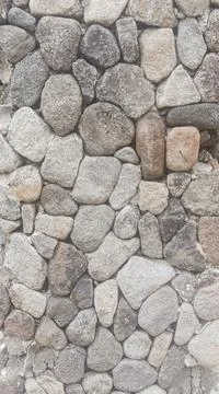 Natural River Stone Wall with Gray and Brown Pebbles Stock-Fotos