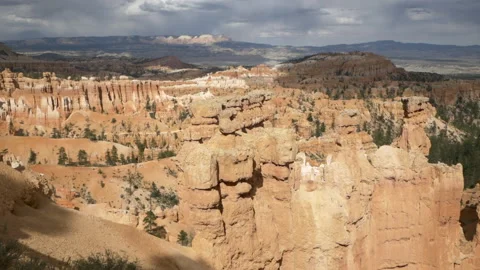 Natural rock formations, storm clouds on the horizon, Navajo Loop Trail, Stock Footage 131301246