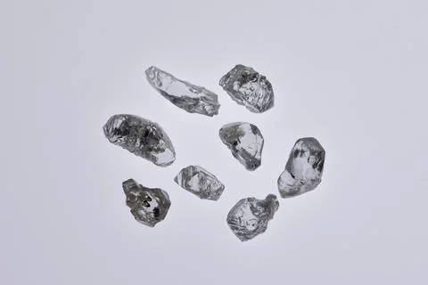Natural rough diamonds in the sorting process close up Stock Photos