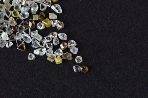Natural rough diamonds in the sorting process close up Stock Photos